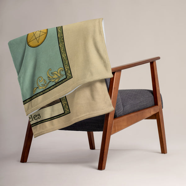 Ace of Pentacles blanket folded and draped over the back of a chair.