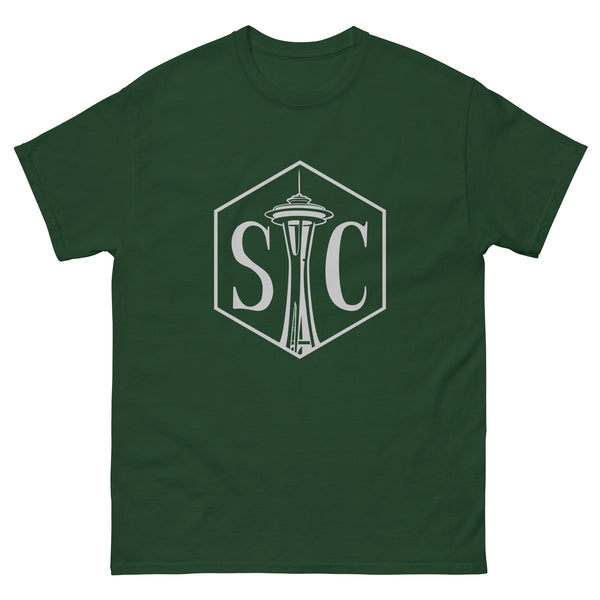 Picture of a green tee shirt with a gray hexagon with the letters "SC" inside the hexagon with the Space Needle between the letters.