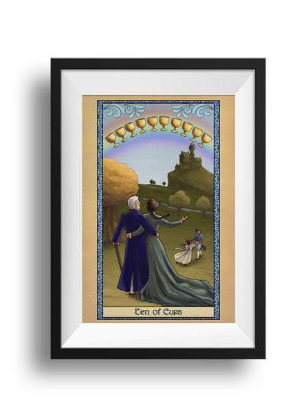 A framed print of the Ten of Cups, featuring a couple standing in each other's arms, looking toward their castle on the hill. Two children play in the field, and a golden tree stands in the distance. In the sky, ten cups float before a rainbow.